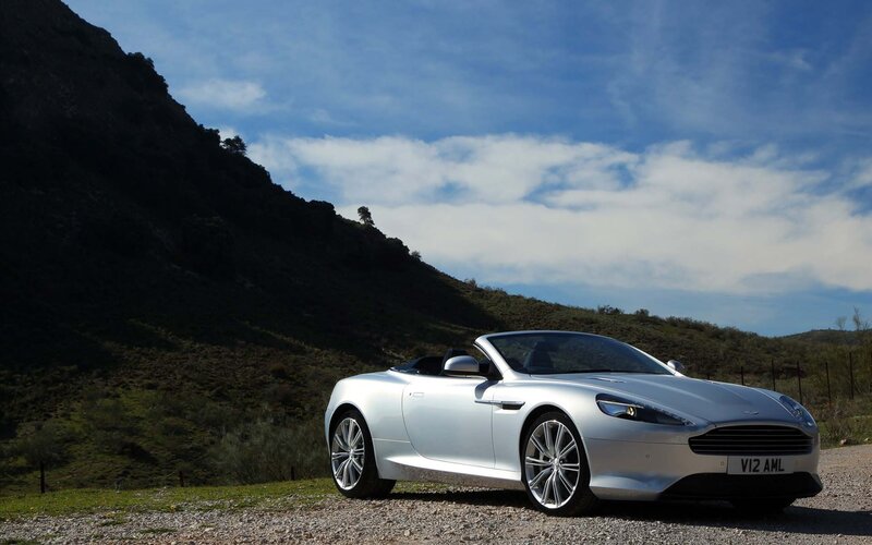 Silver Aston Martin on a hillside
