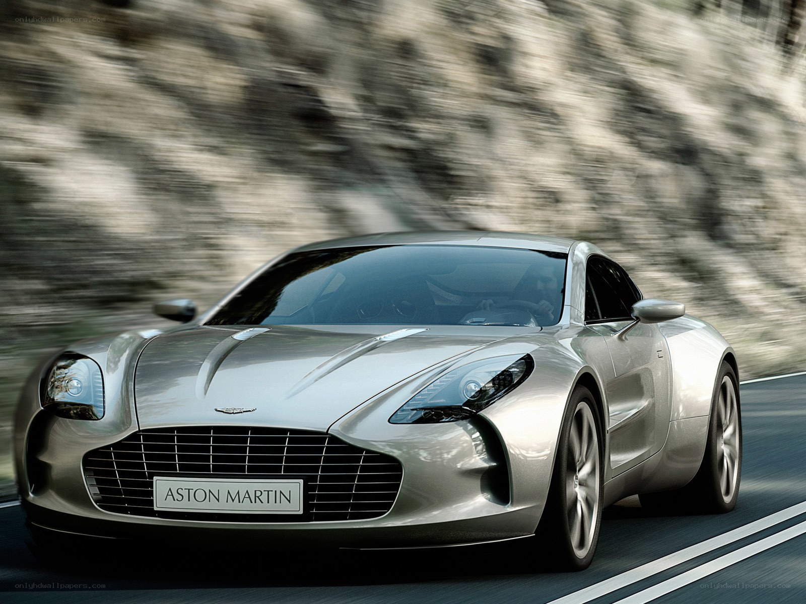 Silver Aston Martin on a road