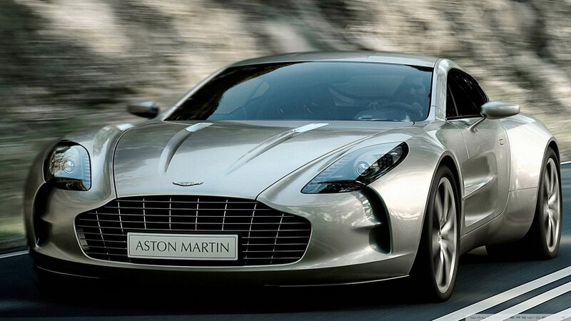 Silver Aston Martin on a road