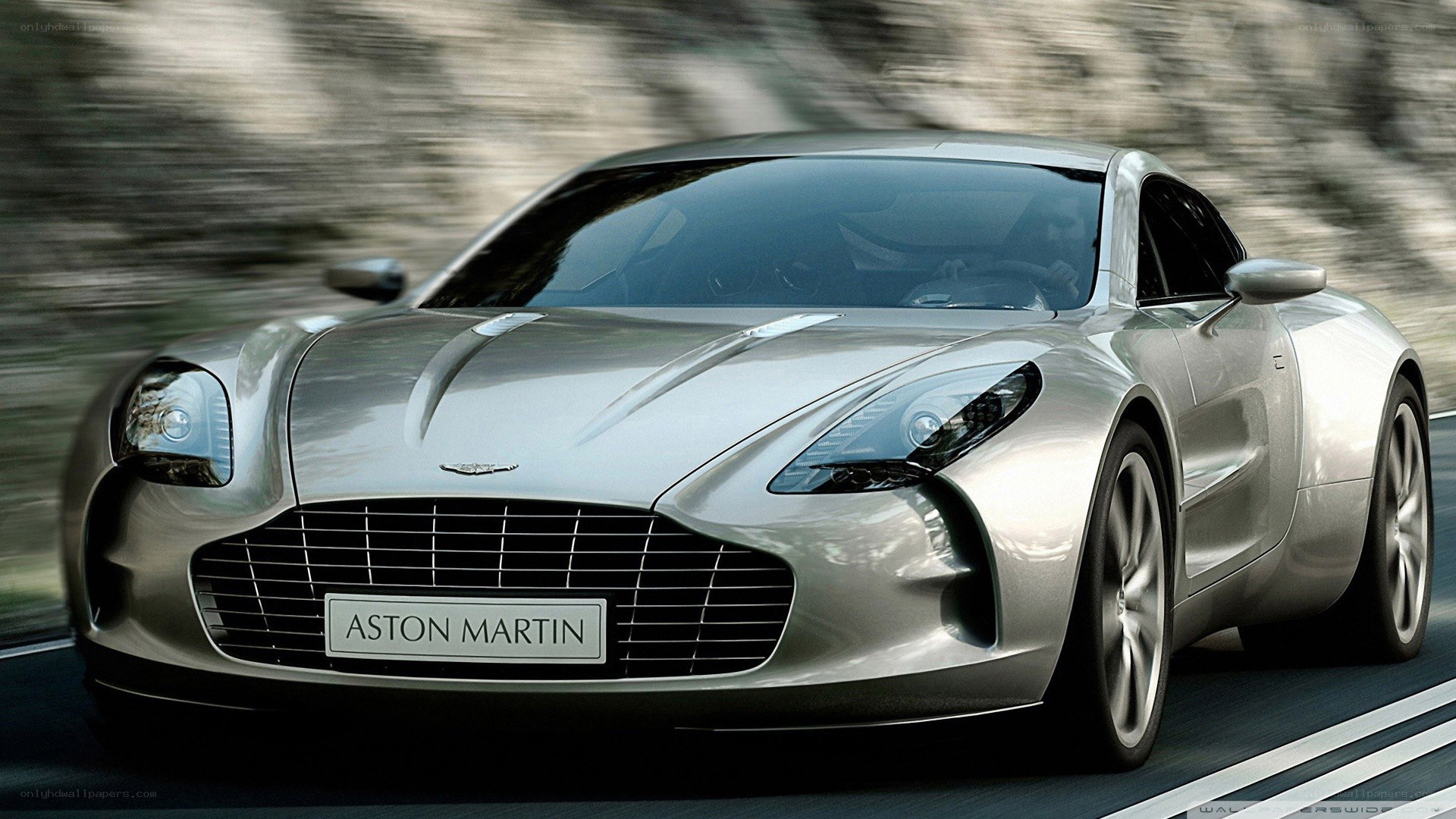 Silver Aston Martin on a road