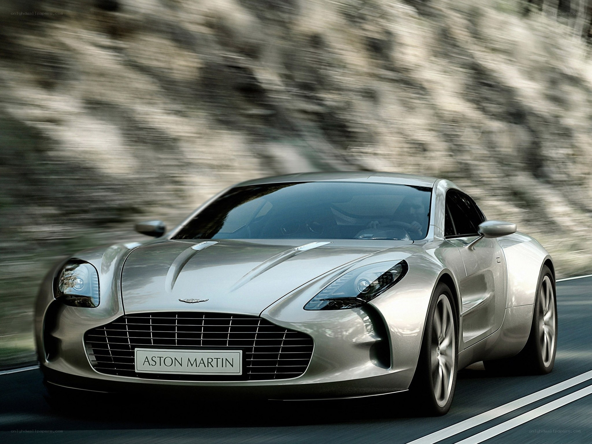 Silver Aston Martin on a road