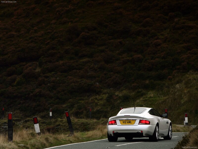 Silver Aston Martin on a winding road