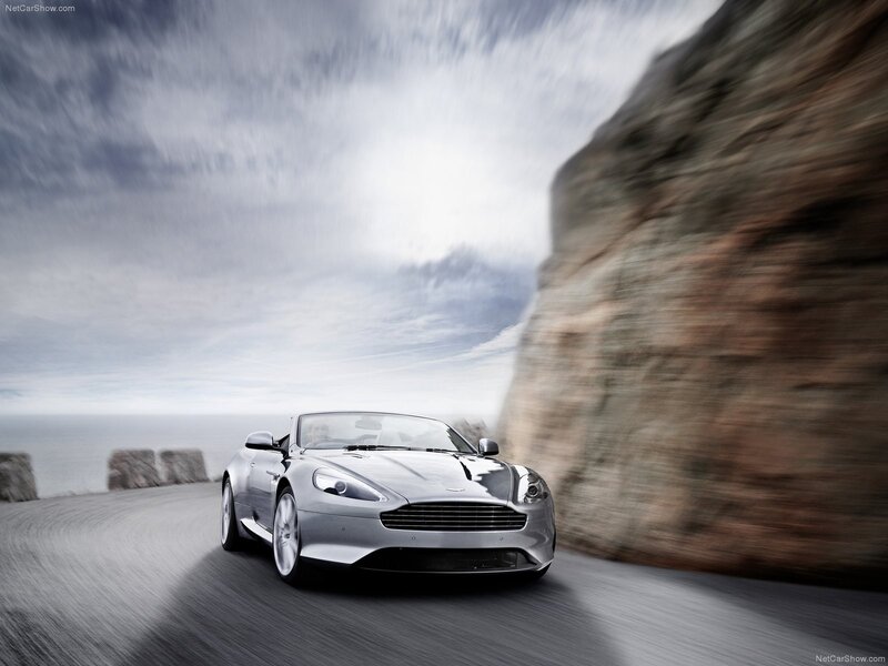 silver aston martin on coastal road