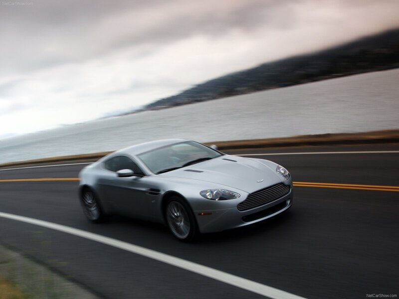 silver aston martin on coastal road