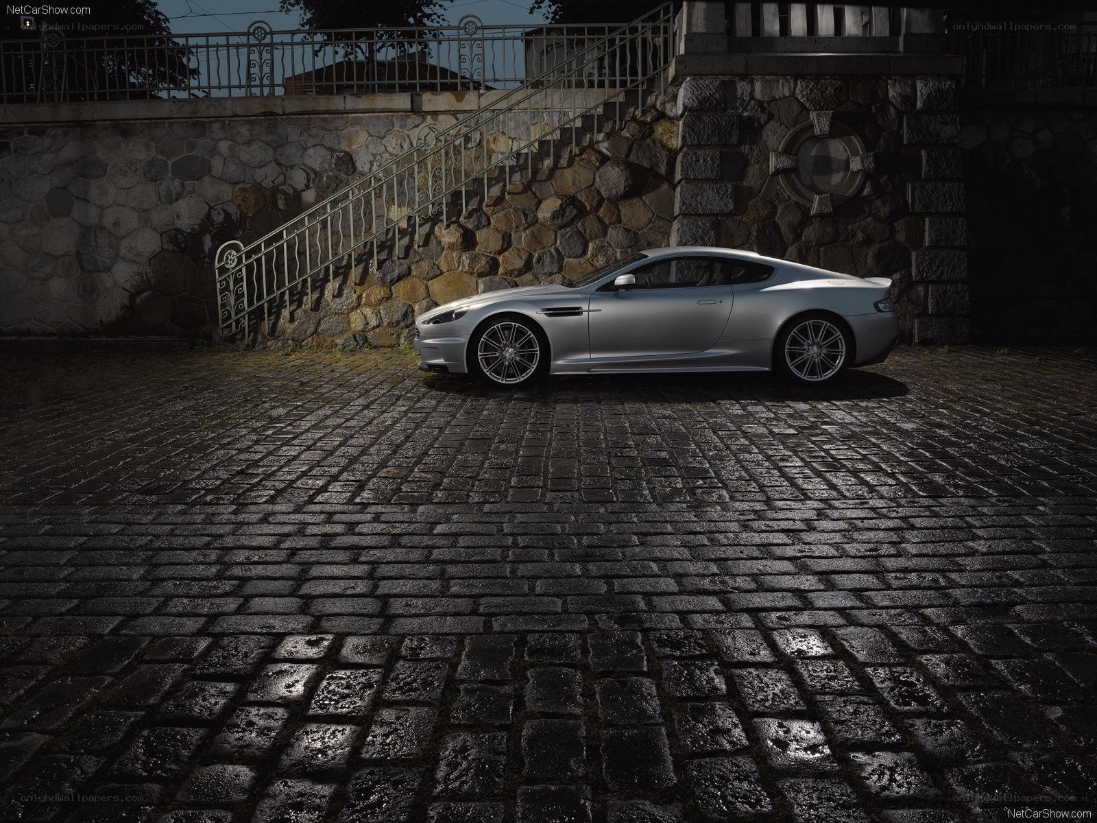 Silver Aston Martin on cobblestones