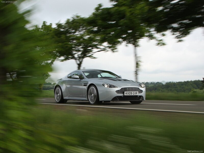 silver aston martin on country road