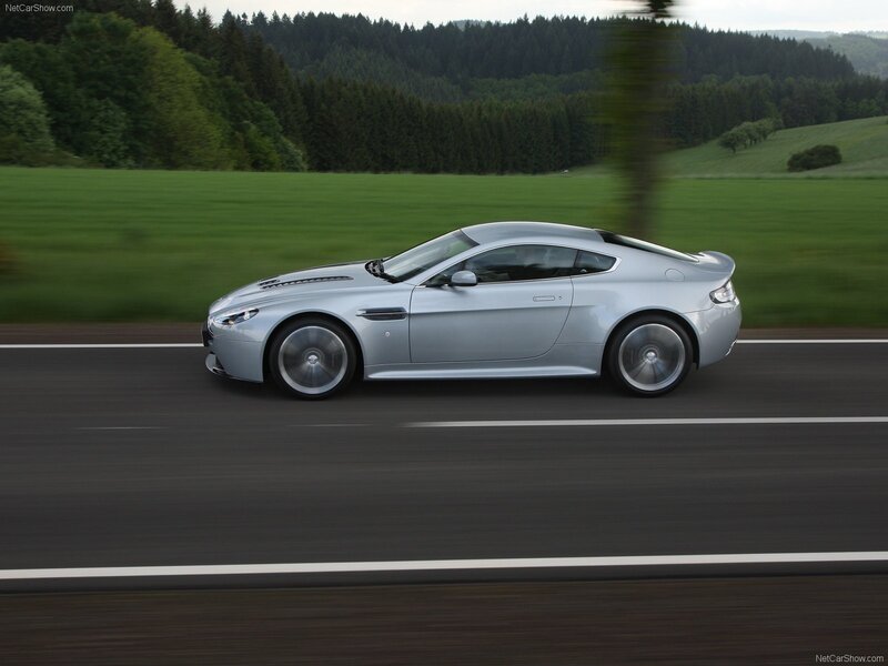 silver aston martin on country road