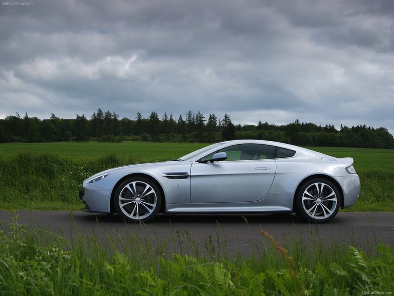 silver aston martin on country road