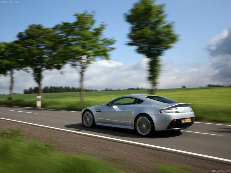 silver aston martin on country road