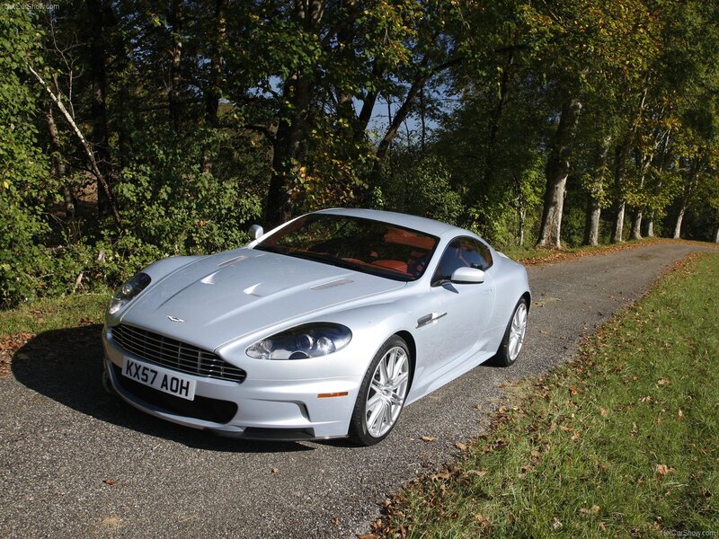 silver aston martin on country road