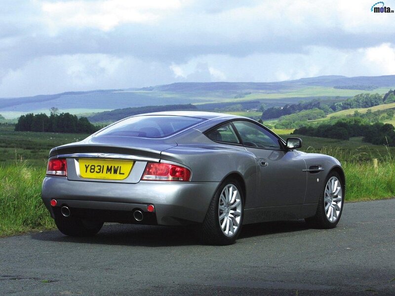 silver aston martin on country road