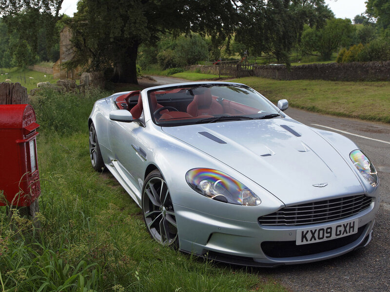Silver Aston Martin on country road
