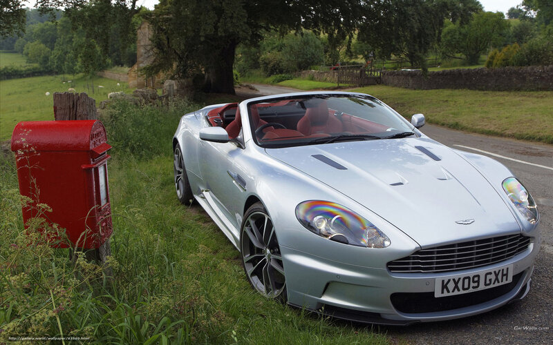 Silver Aston Martin on country road