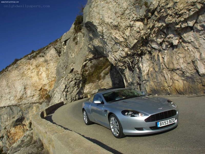 Silver Aston Martin on mountain road