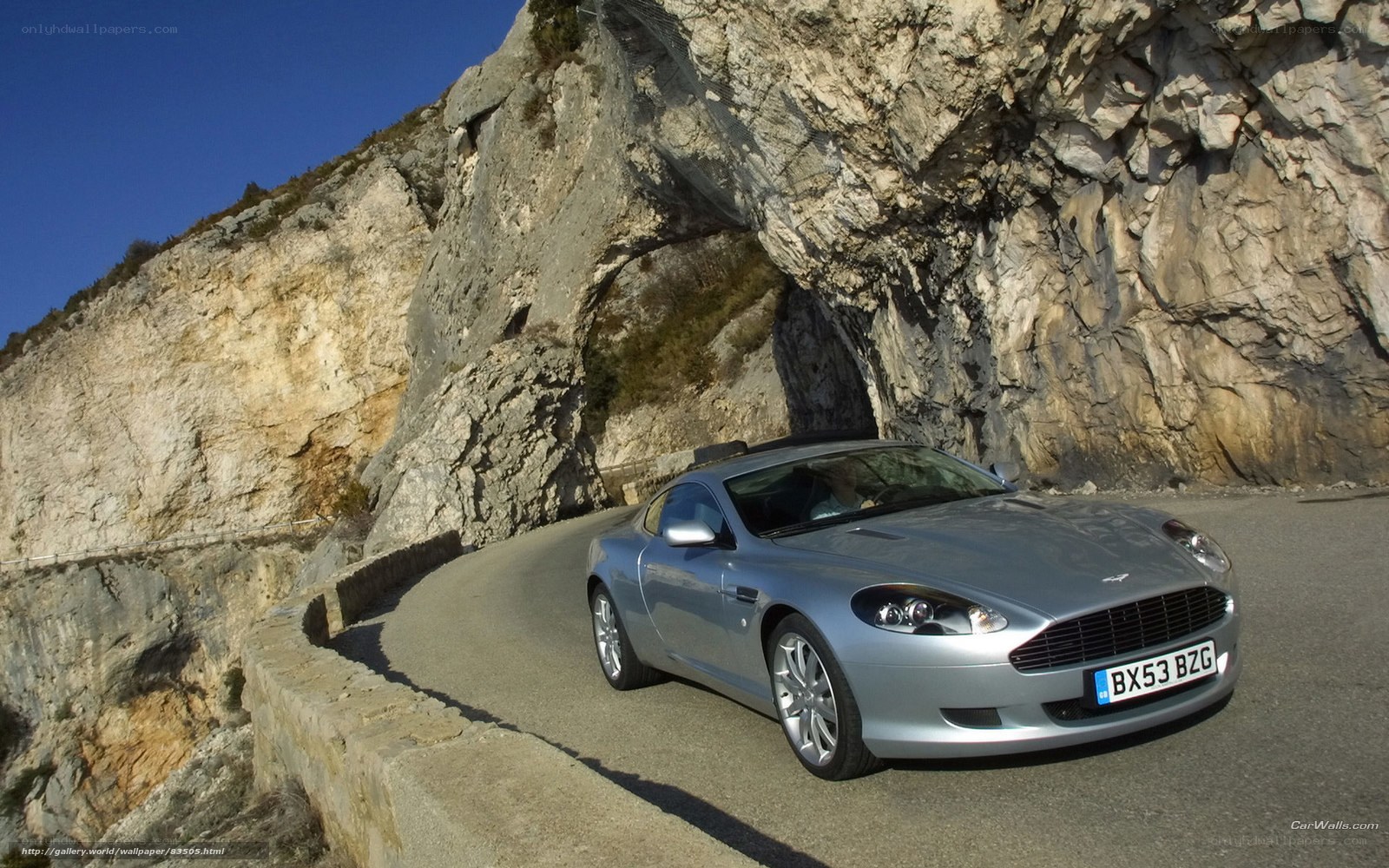 Silver Aston Martin on mountain road