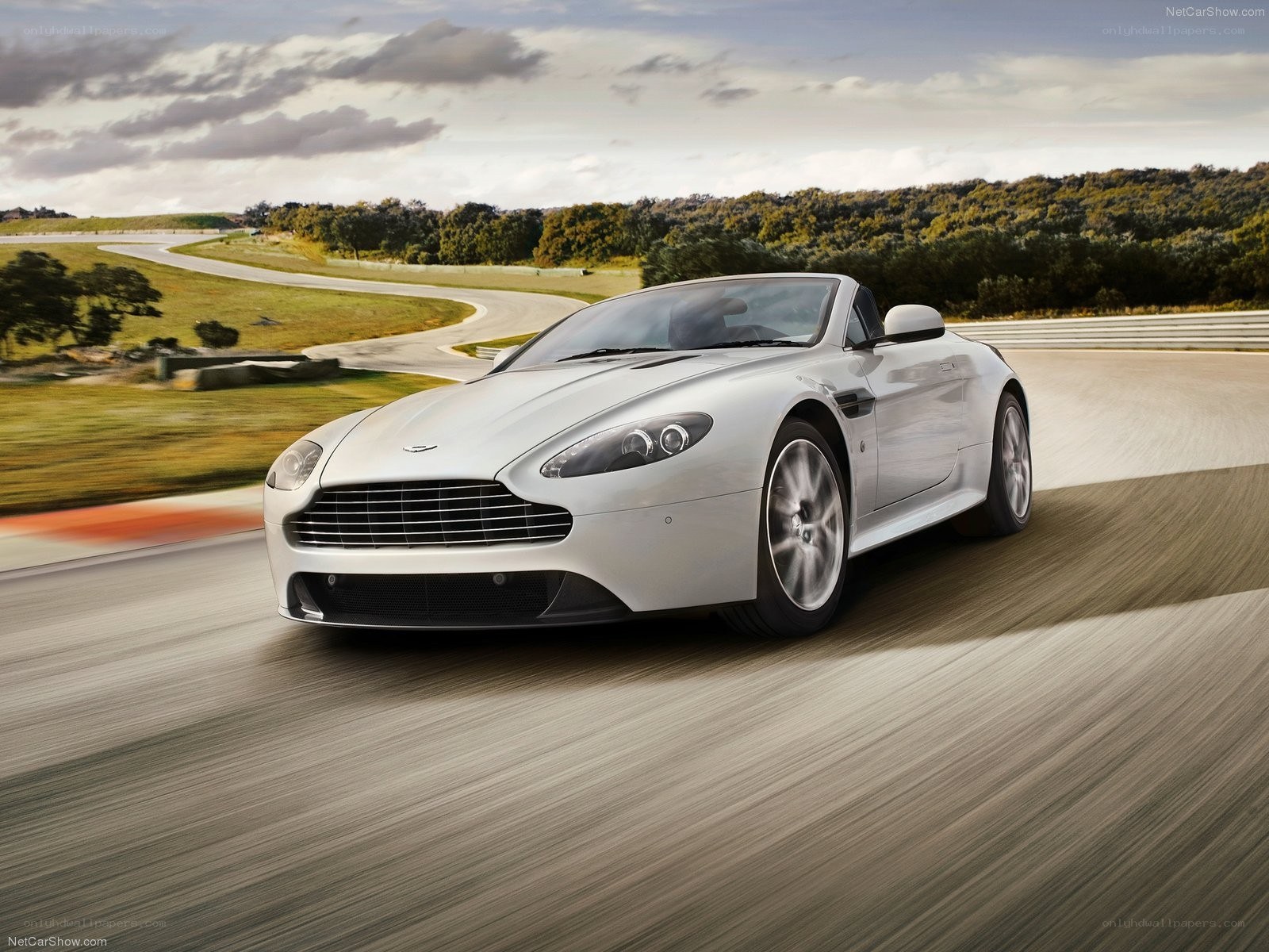 silver aston martin on racetrack