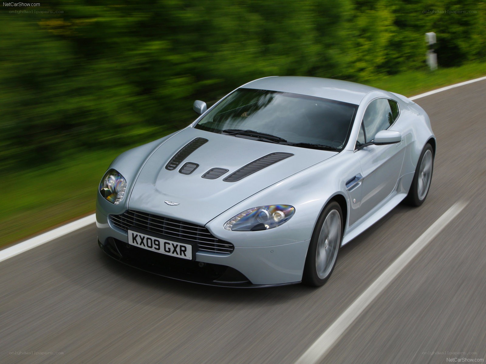 silver aston martin on road