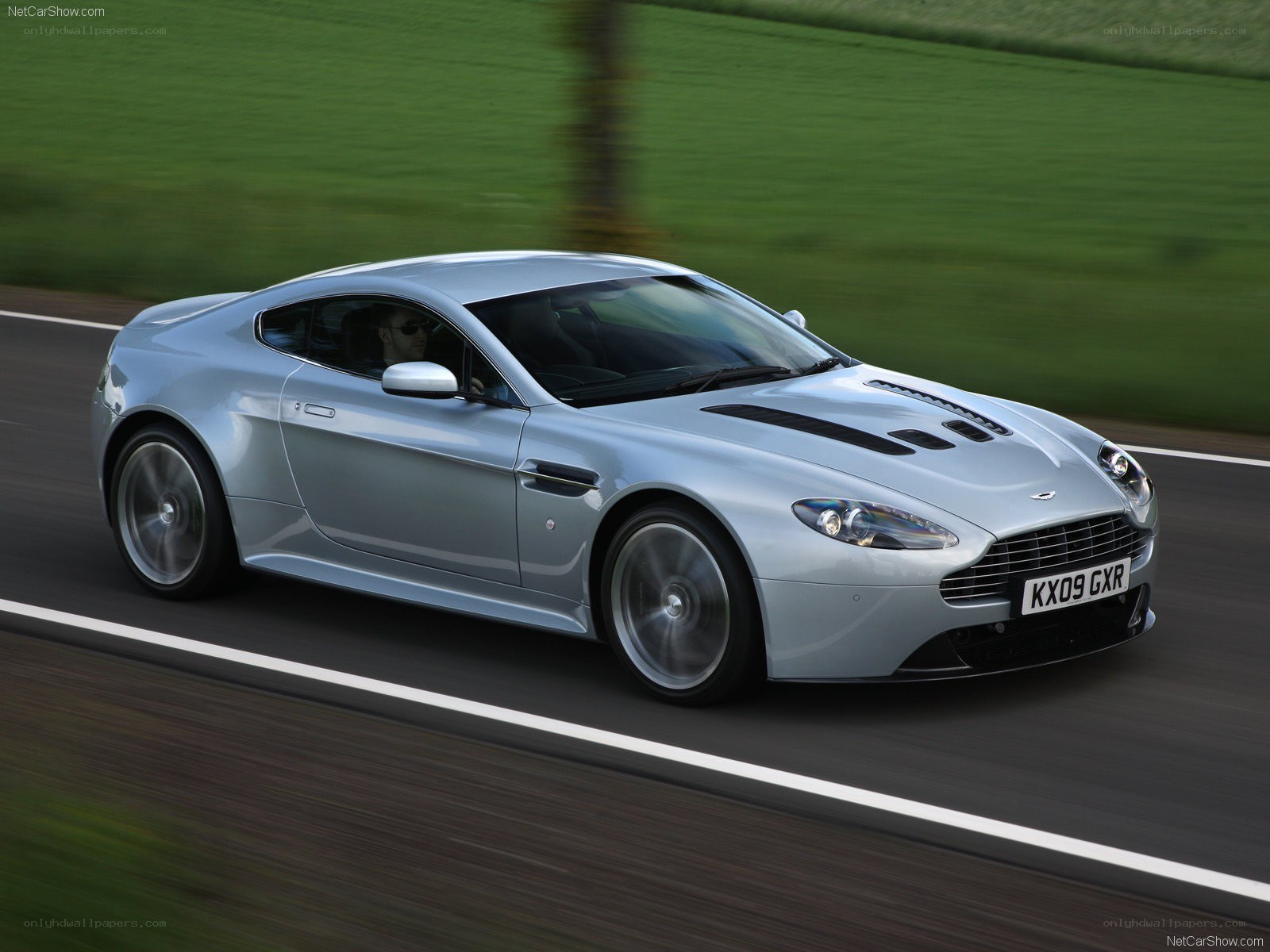 silver aston martin on road