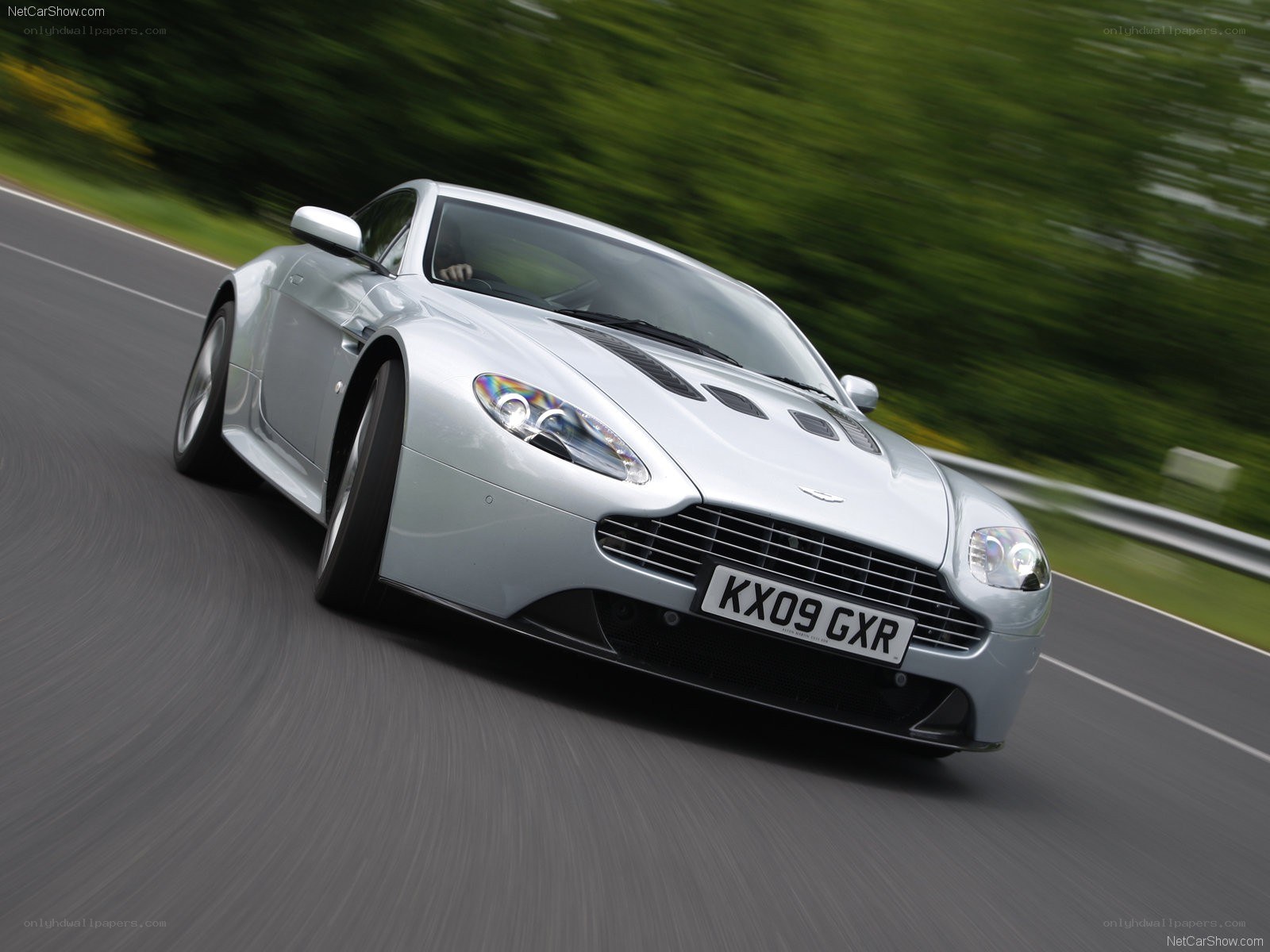 silver aston martin on road