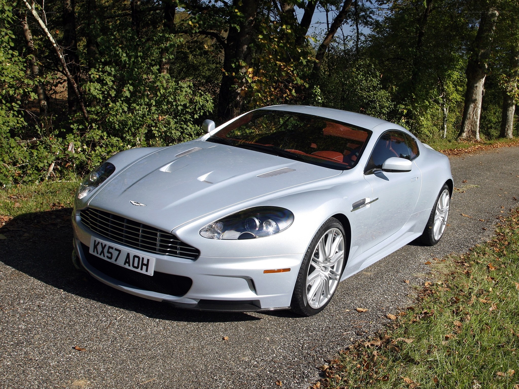 silver aston martin on road
