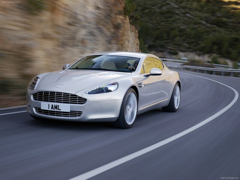 silver aston martin on winding road