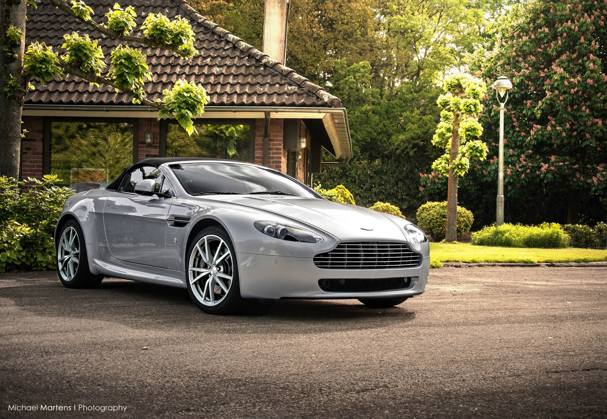 Silver Aston Martin parked outside