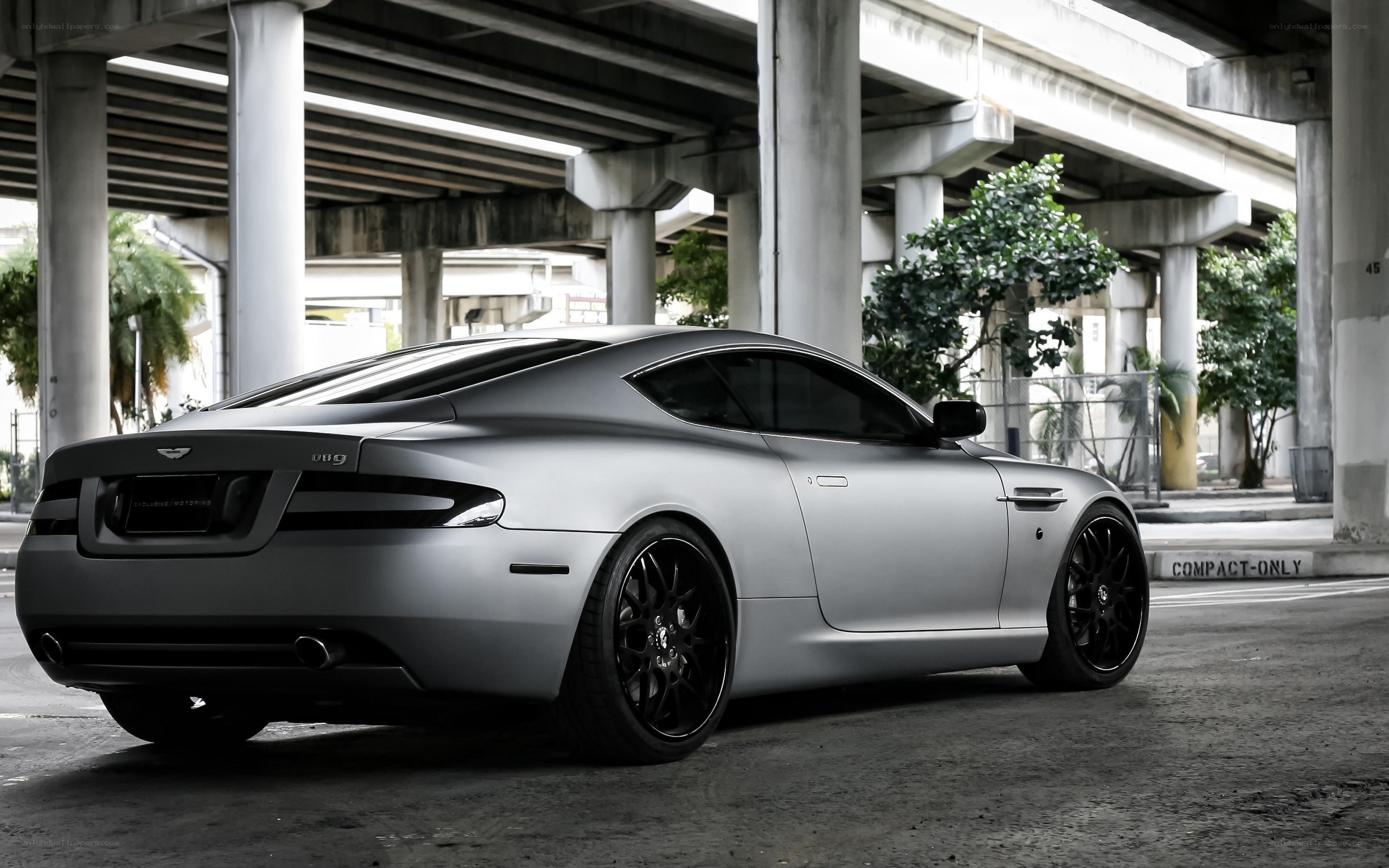 silver aston martin under overpass