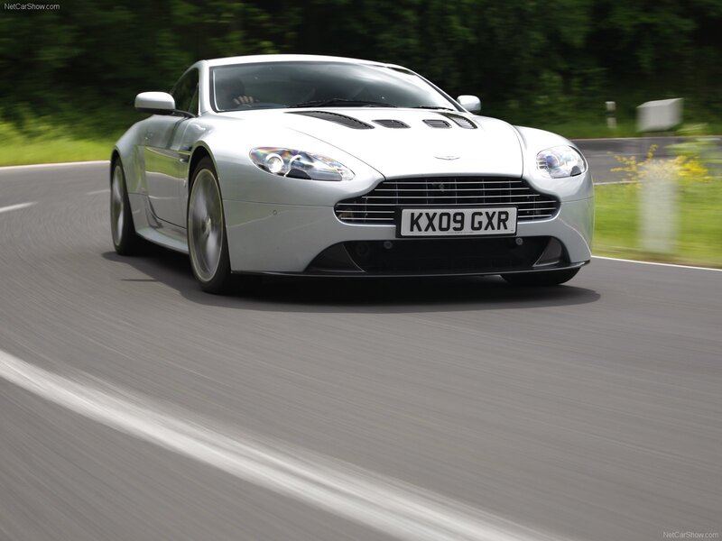 Silver Aston Martin V8 on a road