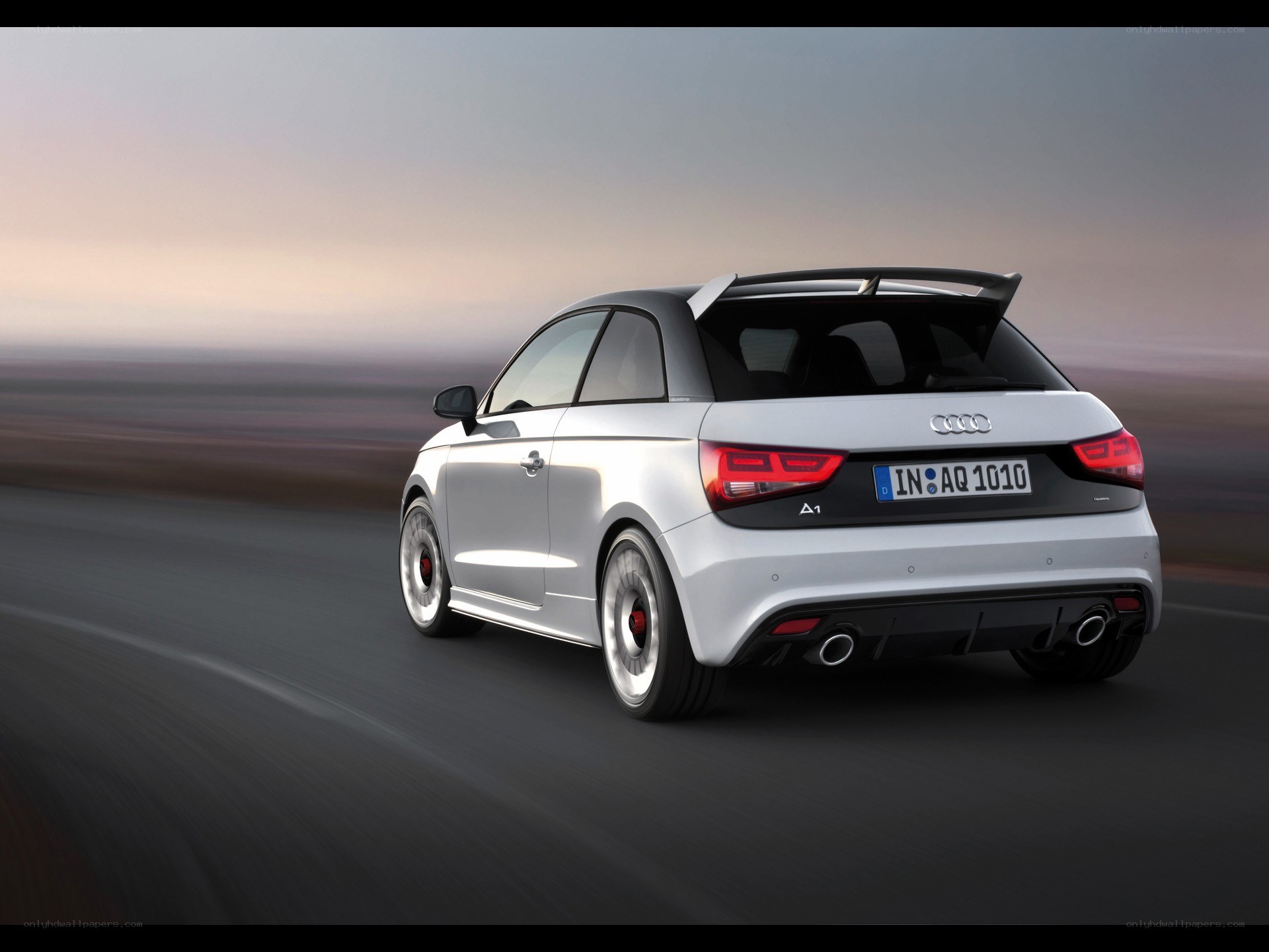 silver audi a1 driving on road
