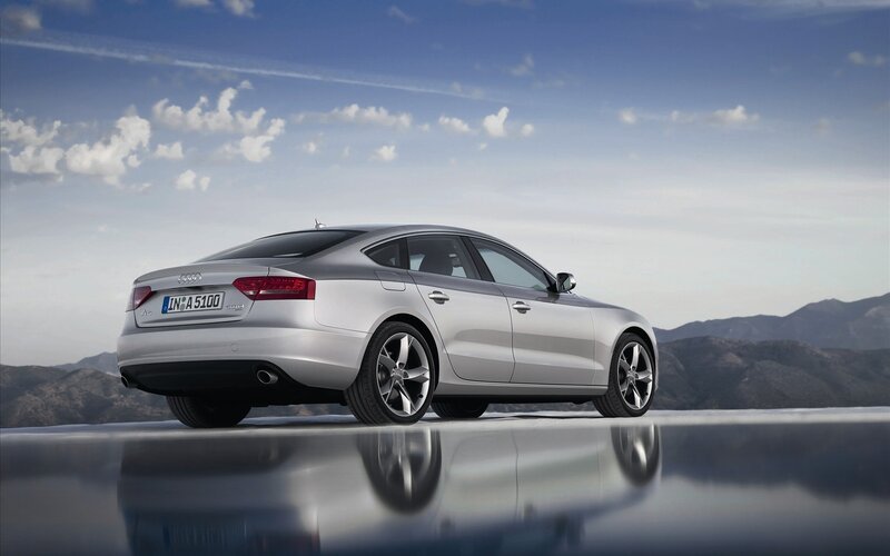 Silver Audi A5 on reflective surface