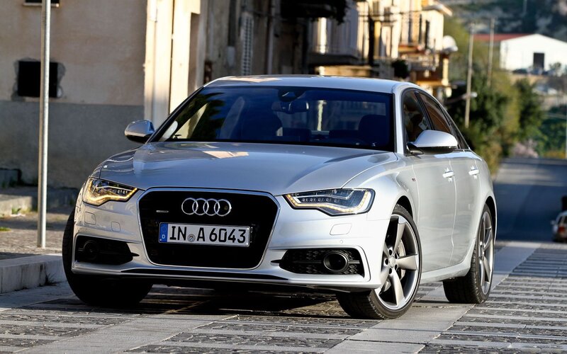 Silver Audi A6 on a cobblestone street