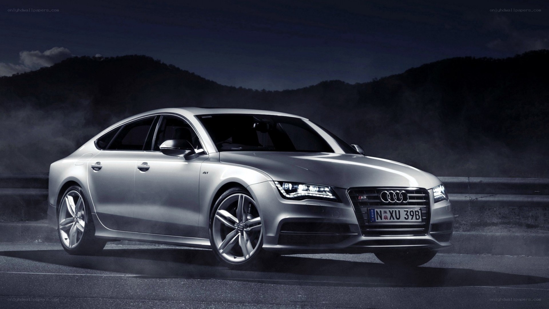 Silver Audi A7 on a dark road