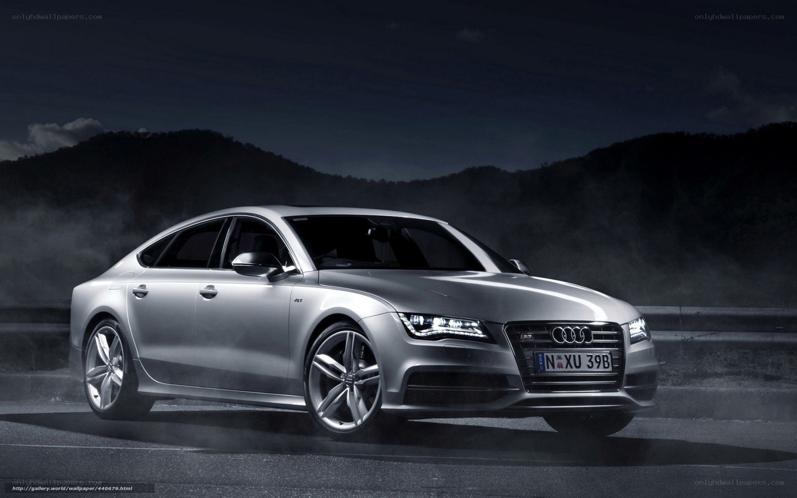 Silver Audi A7 on a dark road
