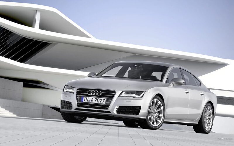 Silver Audi A7 parked outside modern building