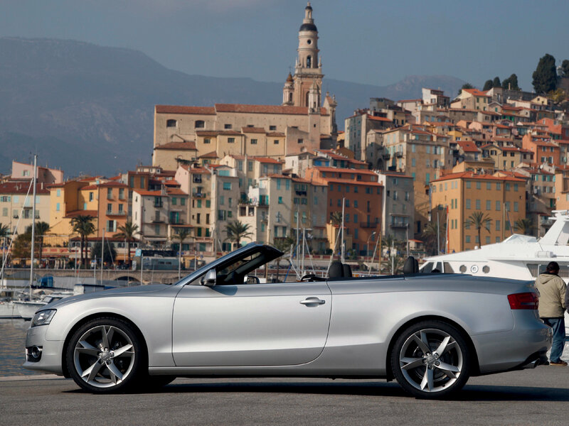 Silver Audi convertible by the harbor