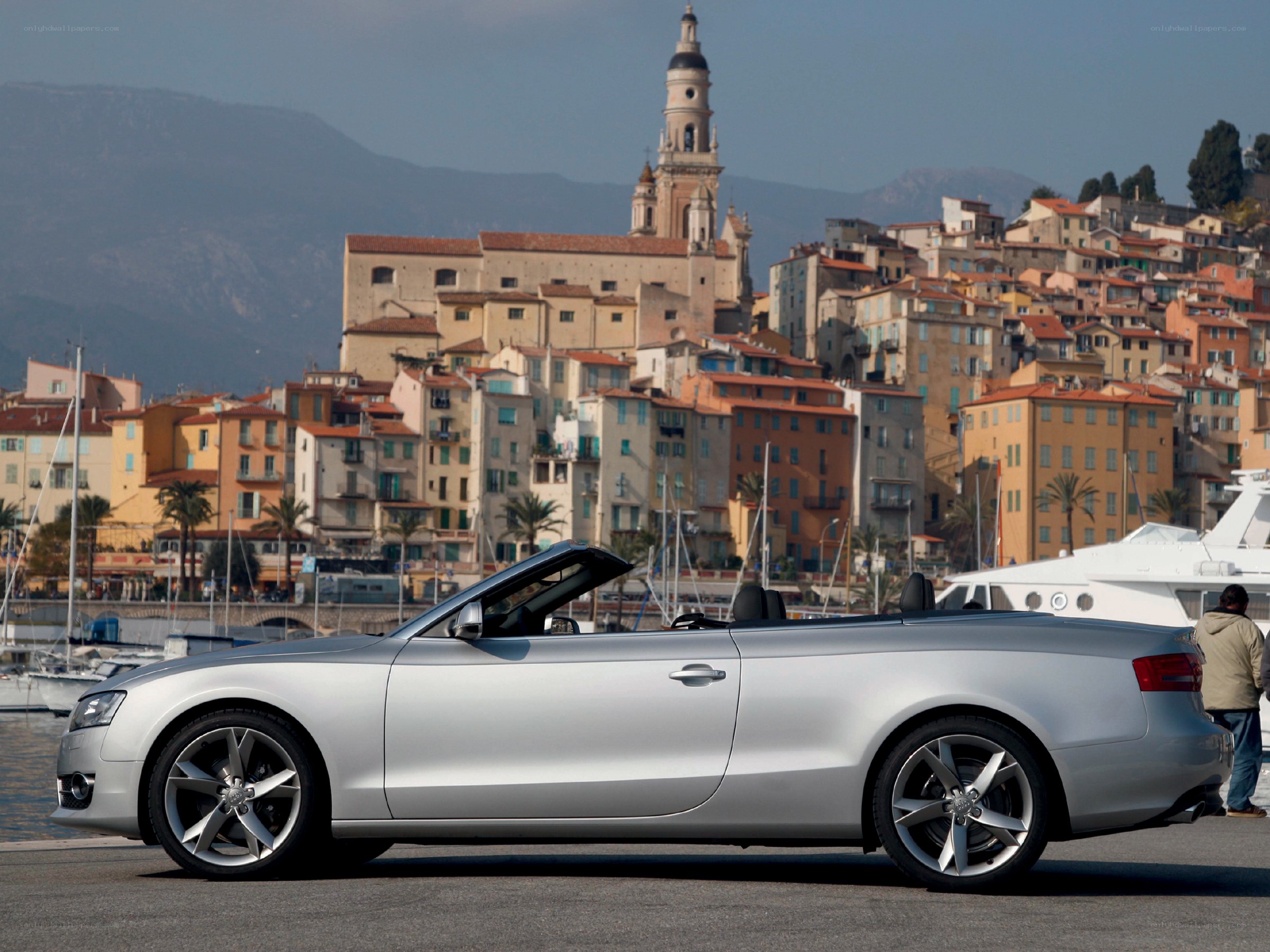 Silver Audi convertible by the harbor