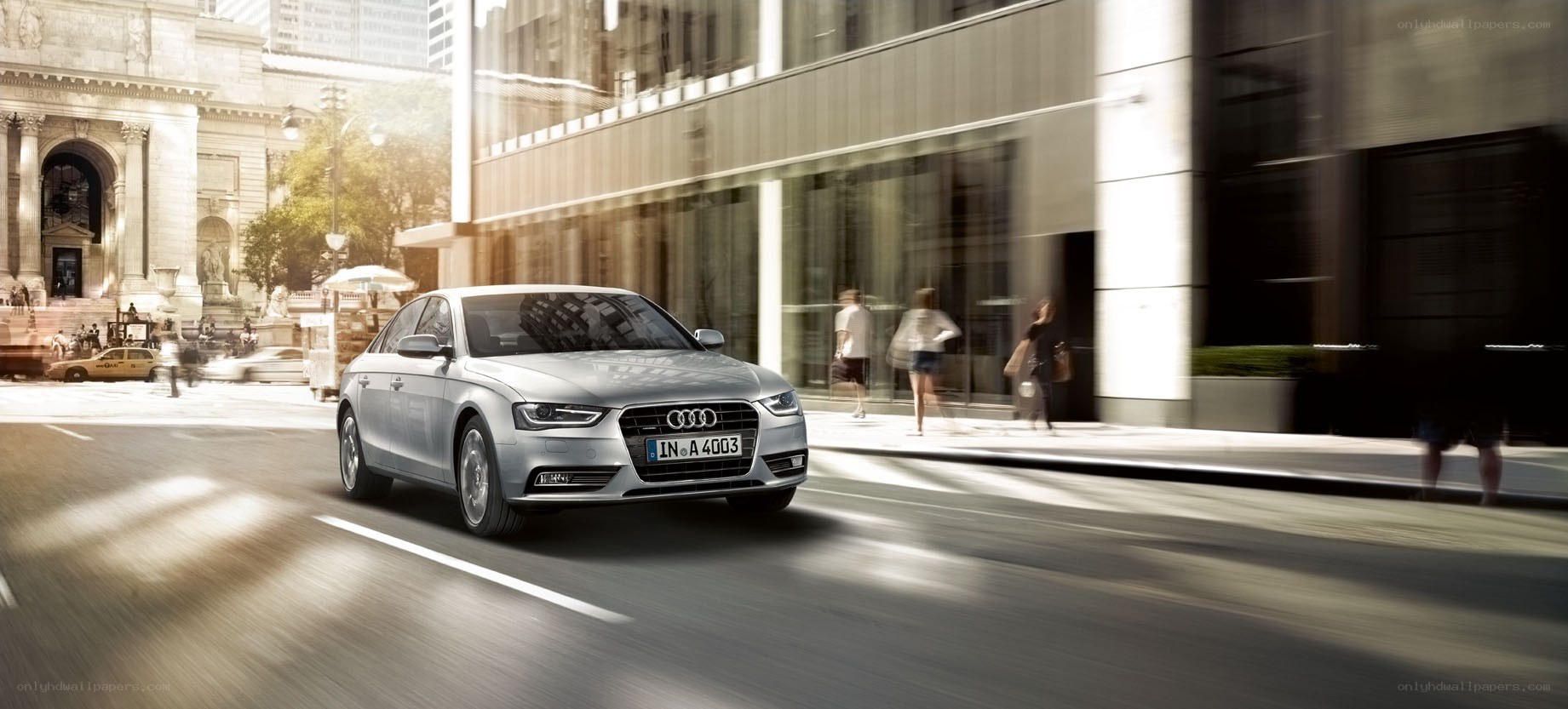 Silver Audi driving in city