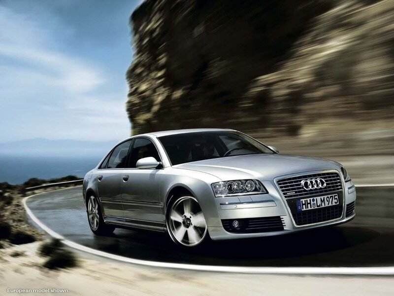 Silver Audi driving on coastal road