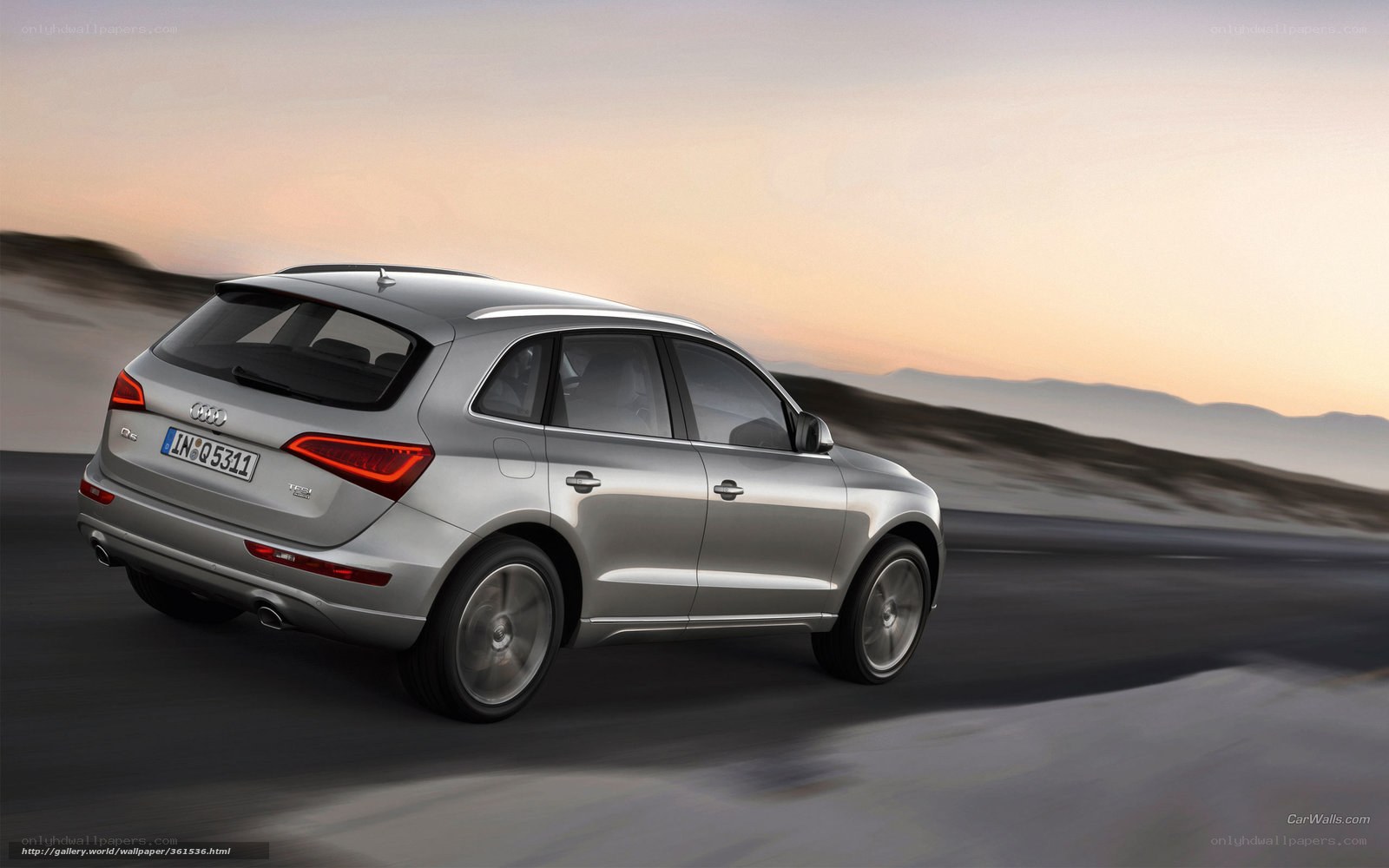 silver audi q5 driving at sunset