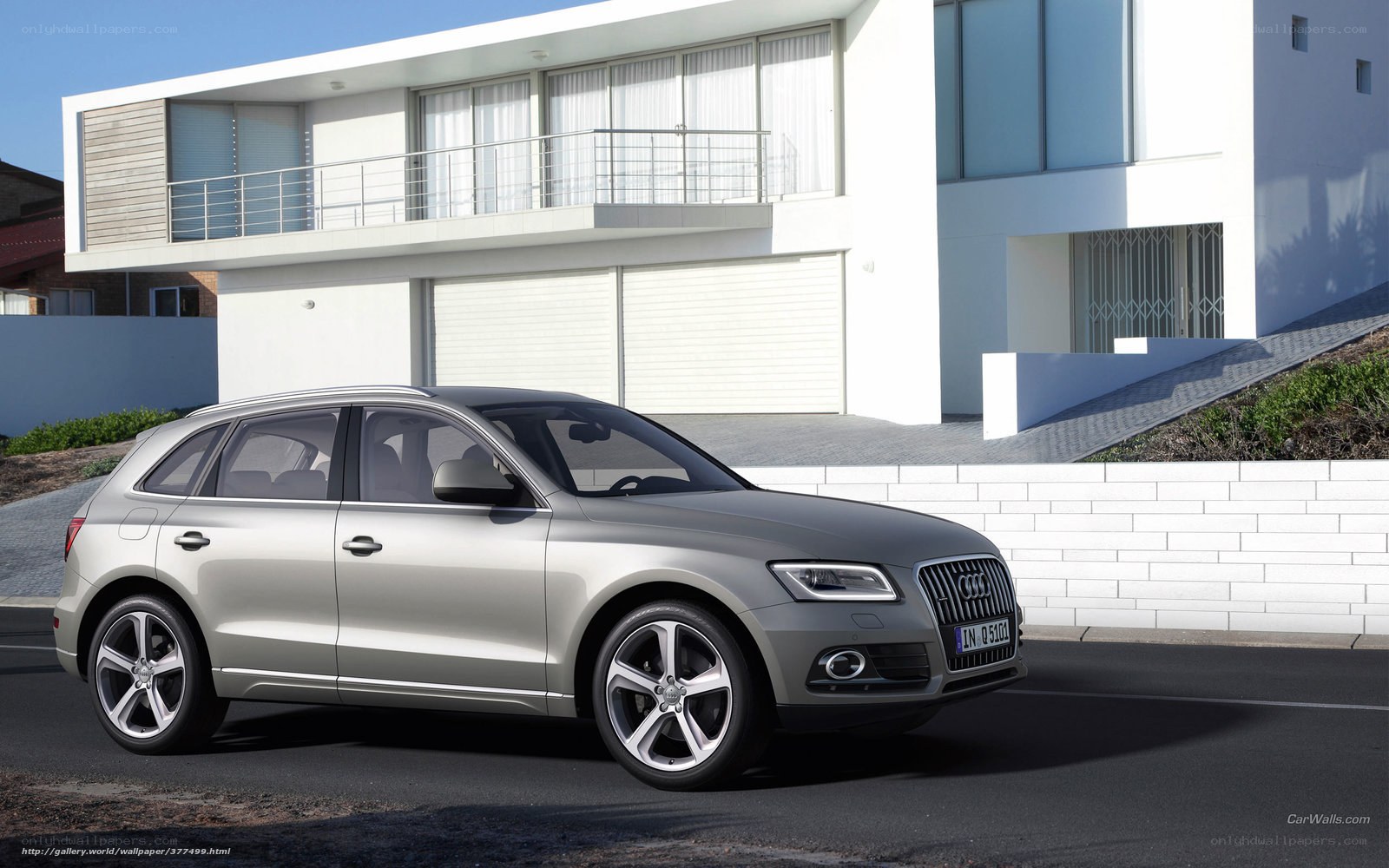 Silver Audi Q5 in front of modern house