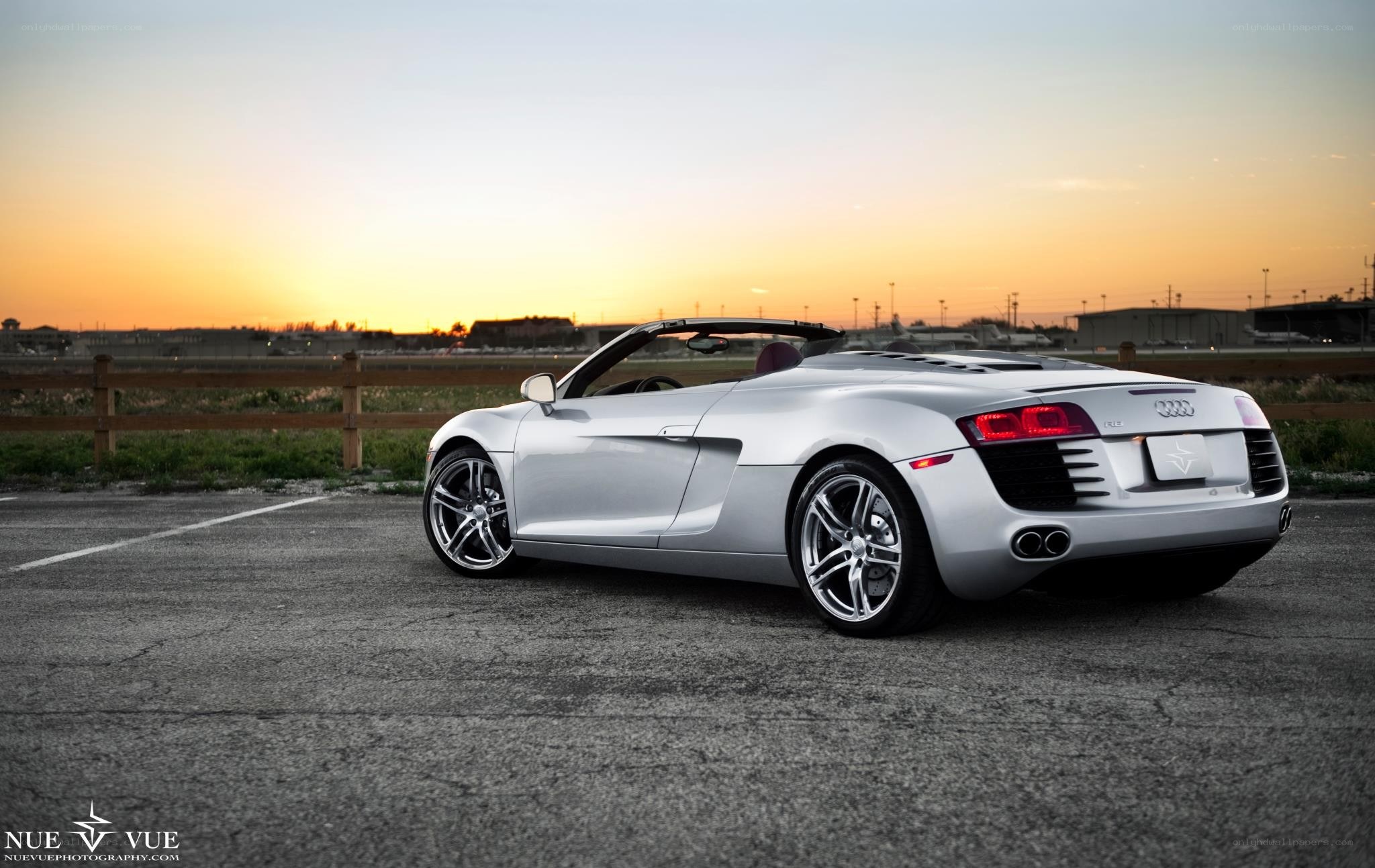 silver audi r8 convertible at sunset