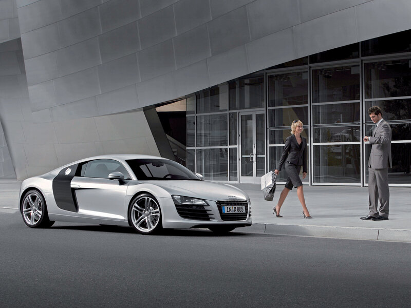 Silver Audi R8 in front of modern building