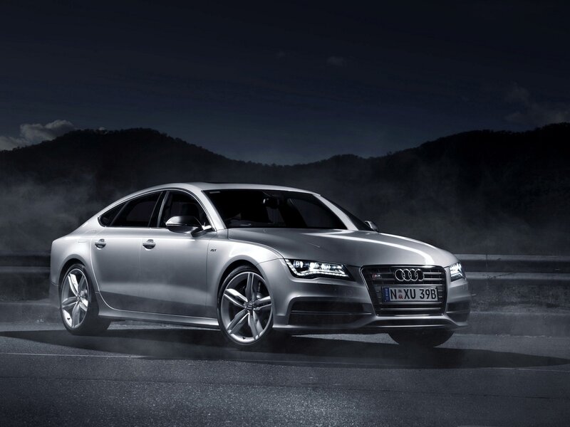 Silver Audi S7 on a dark road