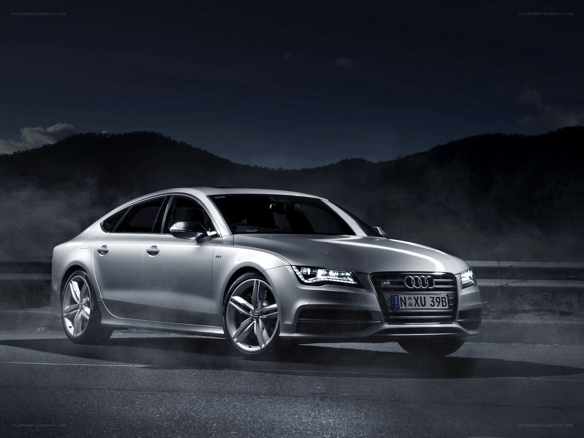 Silver Audi S7 on a dark road