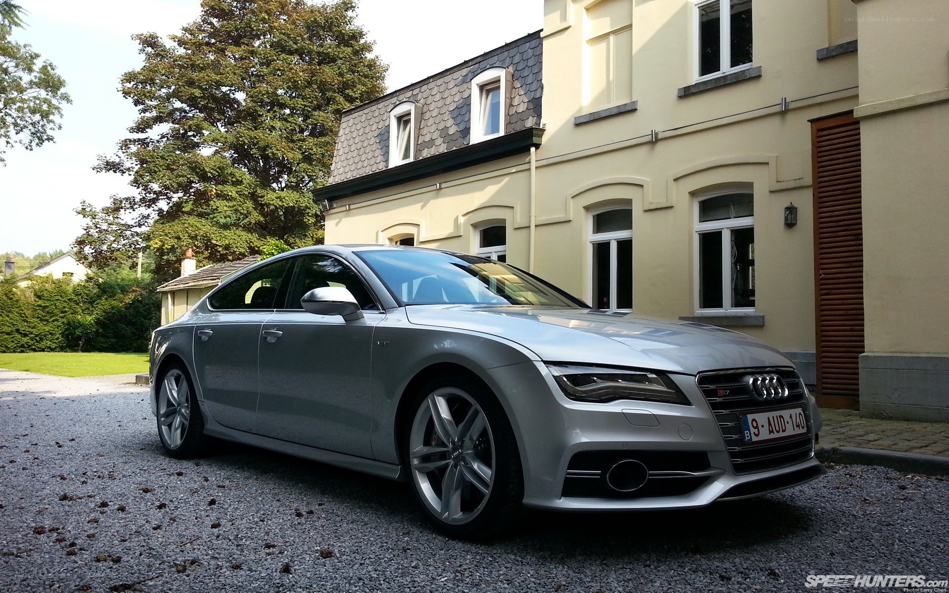 Silver Audi S7 parked outside house