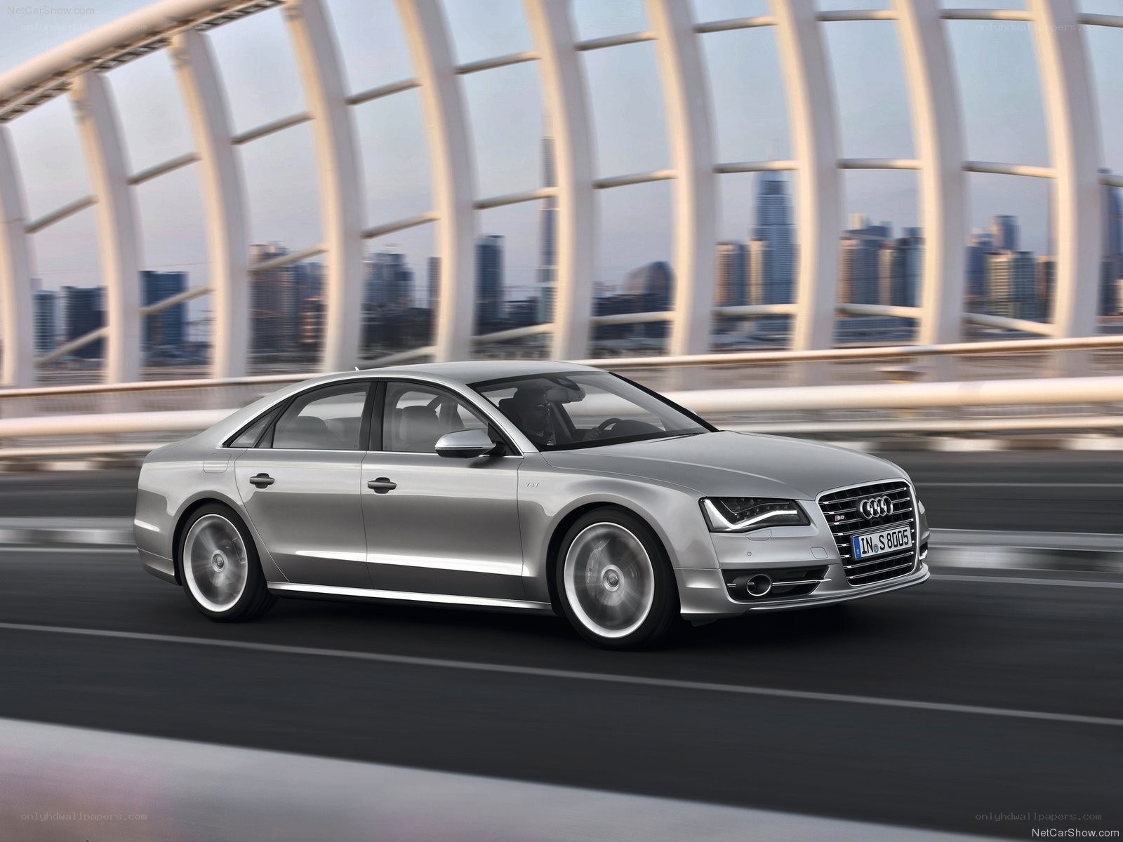 Silver Audi S8 driving on a bridge