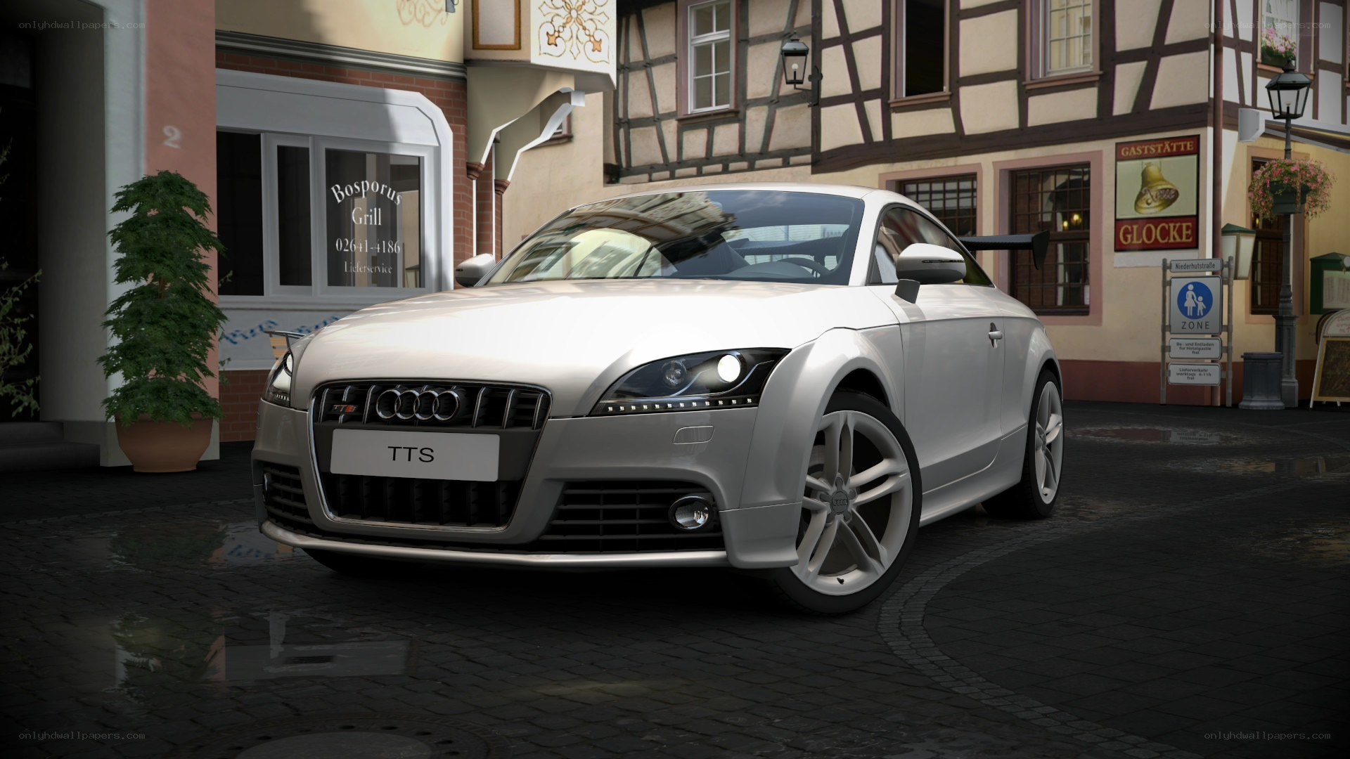 Silver Audi TTS on cobblestone street