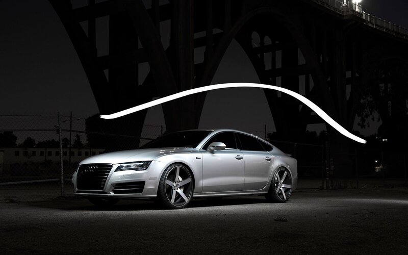 Silver Audi under bridge at night