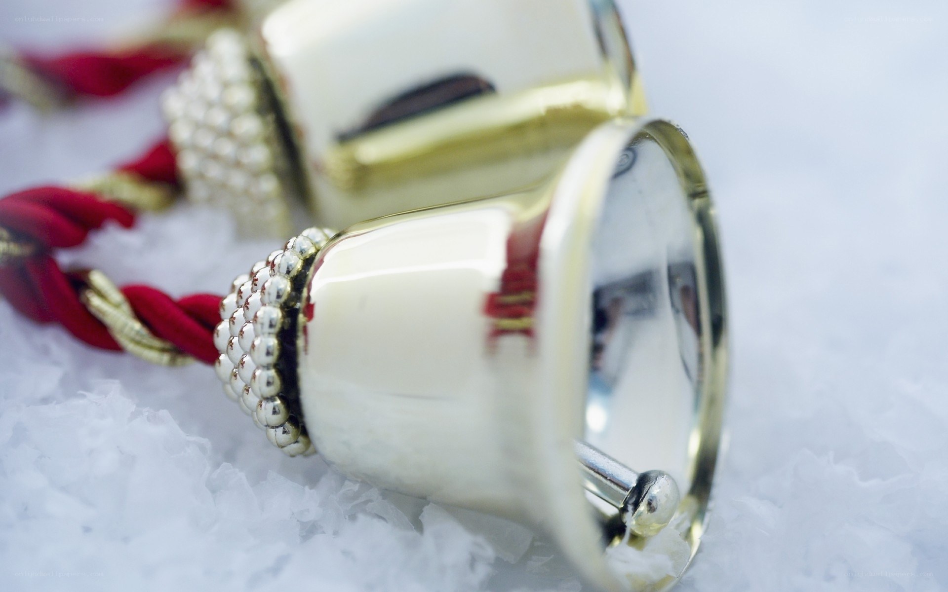 Silver bells on red cord