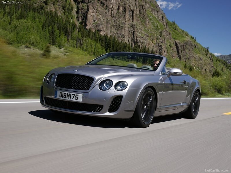 Silver Bentley convertible on mountain road